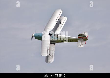 Bücher Jungmann G-BSAJ with the 1936 Berlin Olympics colour scheme flying at the Shuttleworth Flying Festival Airshow on the 2rd June 2019 Stock Photo