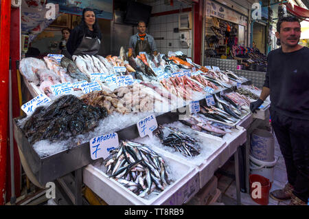 Heraklion, Crete Island / Greece. Fresh fishes on the counter at a fish shop in the central market of Heraklion city. Friendly and smiling people Stock Photo