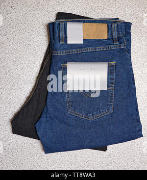 Dark Blue and light blue textured jeans denim with label view from above Stock Photo