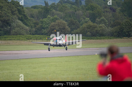 Dunsfold Park, Cranleigh, Surrey, UK. 15th June 2019. 15th and final Dunsfold Wings and Wheels features dynamic air and motoring displays, running from 15th-16th June. The historic WW2 airfield closes shortly to be demolished for new housing. Image: P-51 Mustang WW2 fighter arrives at the airfield. Credit: Malcolm Park/Alamy Live News. Stock Photo