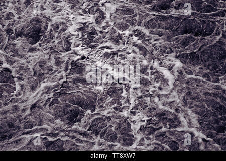 Abstract background, rough water surface. Foaming water, Black and white. Foam and bubbles. Stormy waves. Danger, dramatic and power of nature concept Stock Photo
