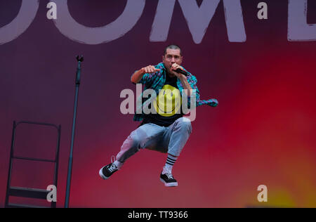 Isle of Wight, UK. 15th June 2019 Dan Smith lead singer jumping on stage with Bastille, Newport, IOW Credit: Dawn Fletcher-Park/Alamy Live News Stock Photo