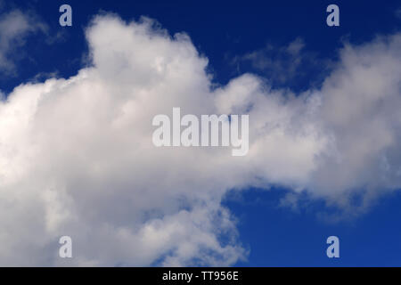 Large clouds in a deep blue sky Stock Photo