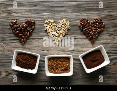 Coffee beans in shape of hearts on wooden background Stock Photo