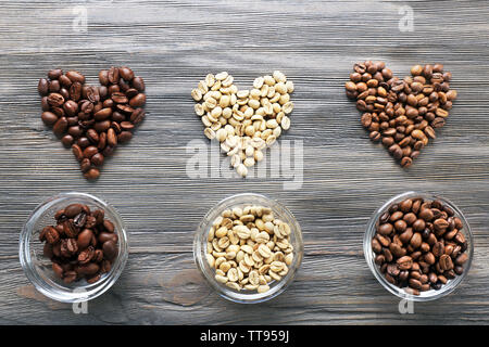 Coffee beans in shape of hearts on wooden background Stock Photo