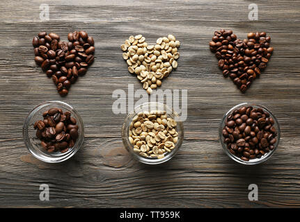 Coffee beans in shape of hearts on wooden background Stock Photo