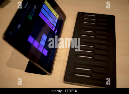 pro tablet for artist with pencil flat lay top view with midi keyboard and synthesizer Stock Photo