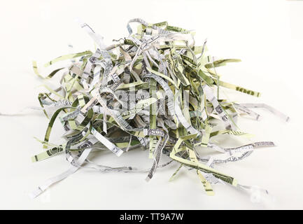 Destroyed money from shredder isolated on white Stock Photo