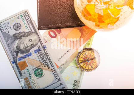 Hand is holding a magnetic compass on black background Stock Photo
