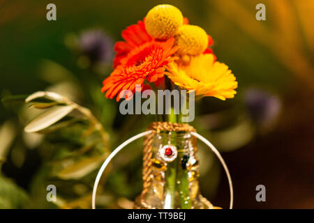 Close-up of Colorful Flowers Decorated with Jewellery Stock Photo