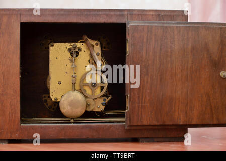 The mechanism of the old clock with the door open Stock Photo