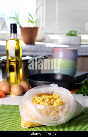 Frozen corn in bag on kitchen table close up Stock Photo