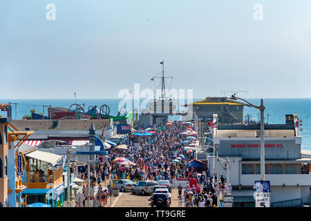 Santa Monica, CA, USA - July 27, 2018 - People enjoying nice sunny weather on the pier, which is at the same time the end of the Route 66, in Santa Mo Stock Photo