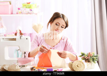 Beautiful young needlewoman in workshop Stock Photo