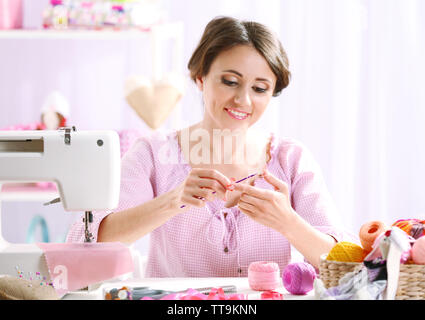 Beautiful young needlewoman in workshop Stock Photo
