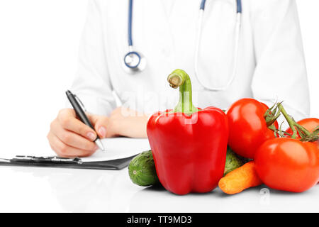 Nutritionist doctor writing  diet plan, isolated on white Stock Photo