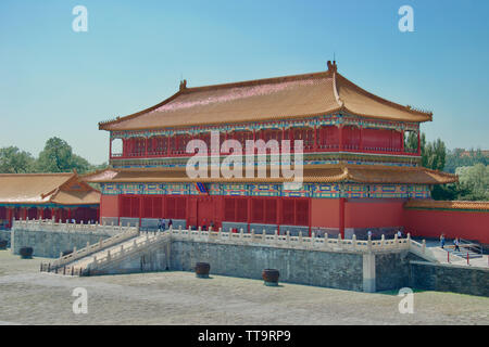 Bright red, yellow, blue, green and orange paint on an ornate, decorated traditional palatial building in the Forbidden City, Beijing, China. Stock Photo