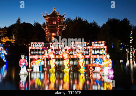 The Dream Lake and the Magic of Lanterns exhibit with the Tower of Condensing Clouds pavilion at dusk in the Chinese Garden, Montreal Botanical Garden Stock Photo