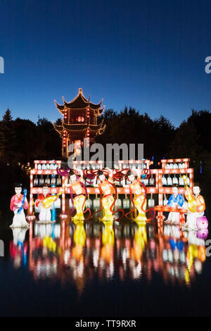 The Dream Lake and the Magic of Lanterns exhibit with the Tower of Condensing Clouds pavilion at dusk in the Chinese Garden, Montreal Botanical Garden Stock Photo