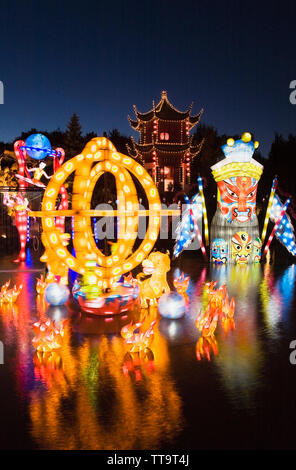 The Dream Lake and the Magic of Lanterns exhibit with the Tower of Condensing Clouds pavilion at dusk in the Chinese Garden, Montreal Botanical Garden Stock Photo