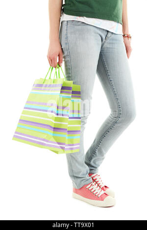 Colorful shopping paper bags in female hand isolated on white Stock Photo