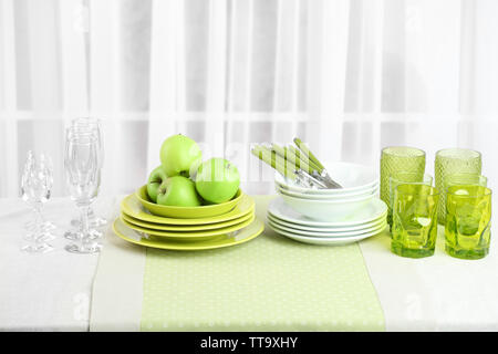 Colorful table settings and tulip flowers in vase on table, on light background Stock Photo