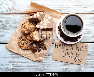 Cup of coffee with fresh croissant and Have A Nice Day massage on wooden table, top view Stock Photo