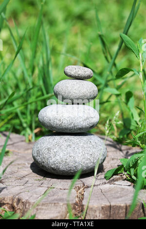 Stack of spa stones over green grass background Stock Photo - Alamy