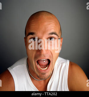 Angry guy with mouth open  with piercing Stock Photo