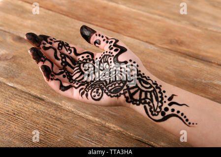 Hand painted with henna on wooden background Stock Photo