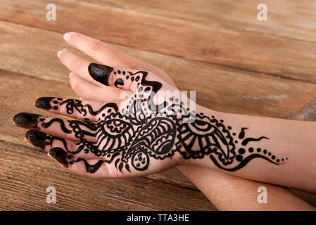 Hand painted with henna on wooden background Stock Photo