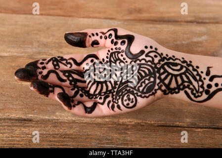 Hand painted with henna on wooden background Stock Photo