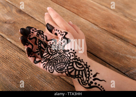 Hand painted with henna on wooden background Stock Photo