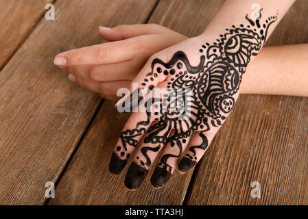 Hand painted with henna on wooden background Stock Photo