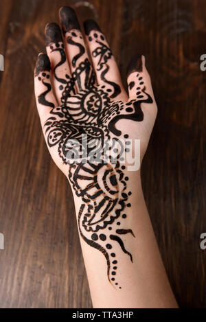 Hand painted with henna on wooden background Stock Photo