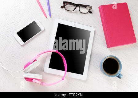 Headphones and other devices on worktop, closeup Stock Photo