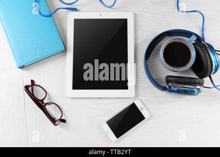 Headphones and other devices on worktop, closeup Stock Photo