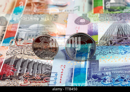 Kuwaiti dinar coins on the background of banknotes Stock Photo