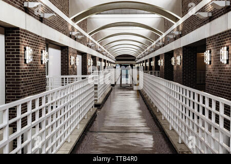 receding lines converge sharply in this view of a skybridge as seen form the perspective of a pedestrian Stock Photo