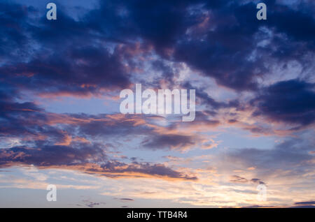 Bright Cumulus clouds in sunset light after the rain Stock Photo