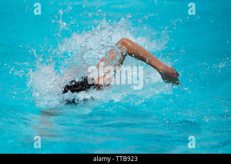 Unrecognized athletes swimming on a swimming pool during a waterpolo championship game Stock Photo