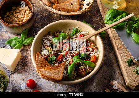 Organic salad with basil pesto and nuts, topped with cheese and crispy toast Stock Photo