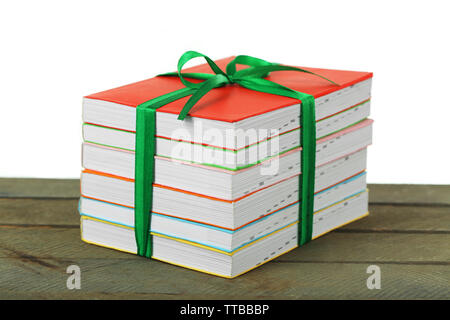 Stack of books with ribbon on light background Stock Photo