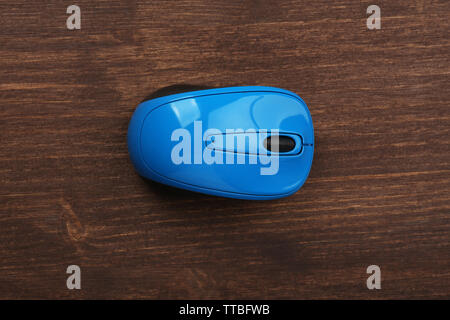 Wireless computer mouse on wooden background Stock Photo