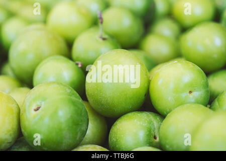 Green plums close-up. Fresh plums (cherry plums) background pattern close up, top view Stock Photo