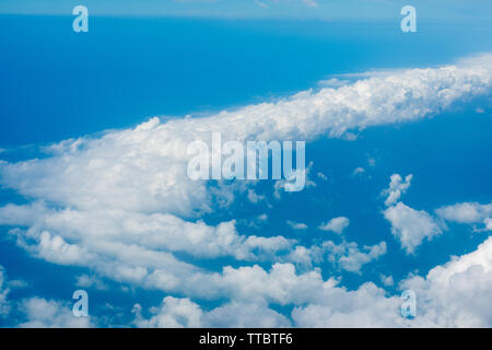 Arial view from internal cabin of aeroplane.Clouds in the sky and cityscapes though airplane window. Stock Photo