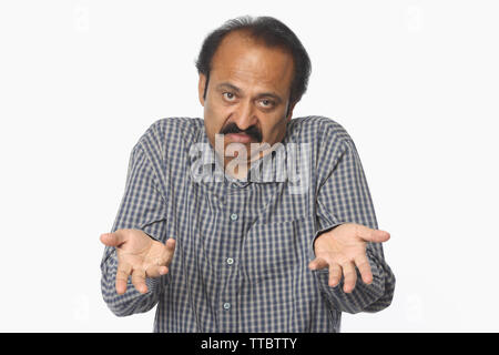 Portrait of an Indian mature man gesturing Stock Photo