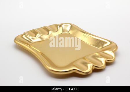 Vintage black and golden promotional souvenir ashtray Cinzano, isolated on a white background, close up Stock Photo