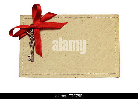 Stitched cardboard with red ribbon and a key for Valentine's day isolated on white Stock Photo