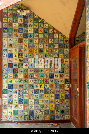 Colourful ceramic tiles on a wall at an entrance to a building. Stock Photo